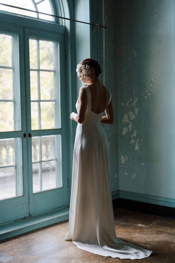 bride in blue room of mansion wearing wedding dress