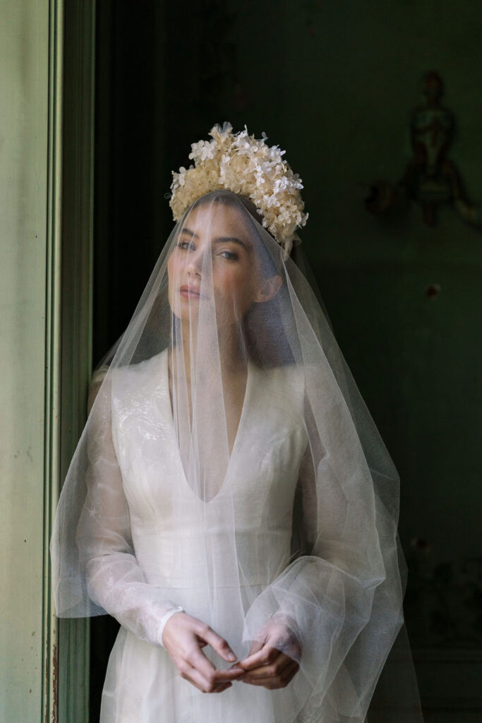 bridal portrait of bride in wedding dress and veil over her face